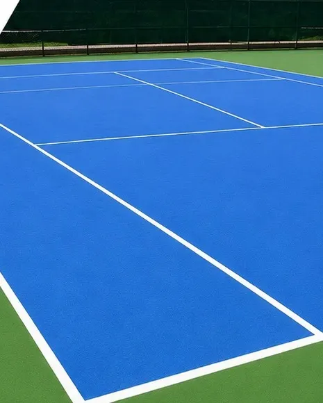Outdoor tennis court with a blue acrylic surface and green surround